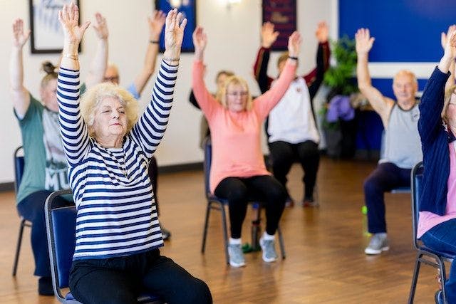 seniors doing short chair exercises